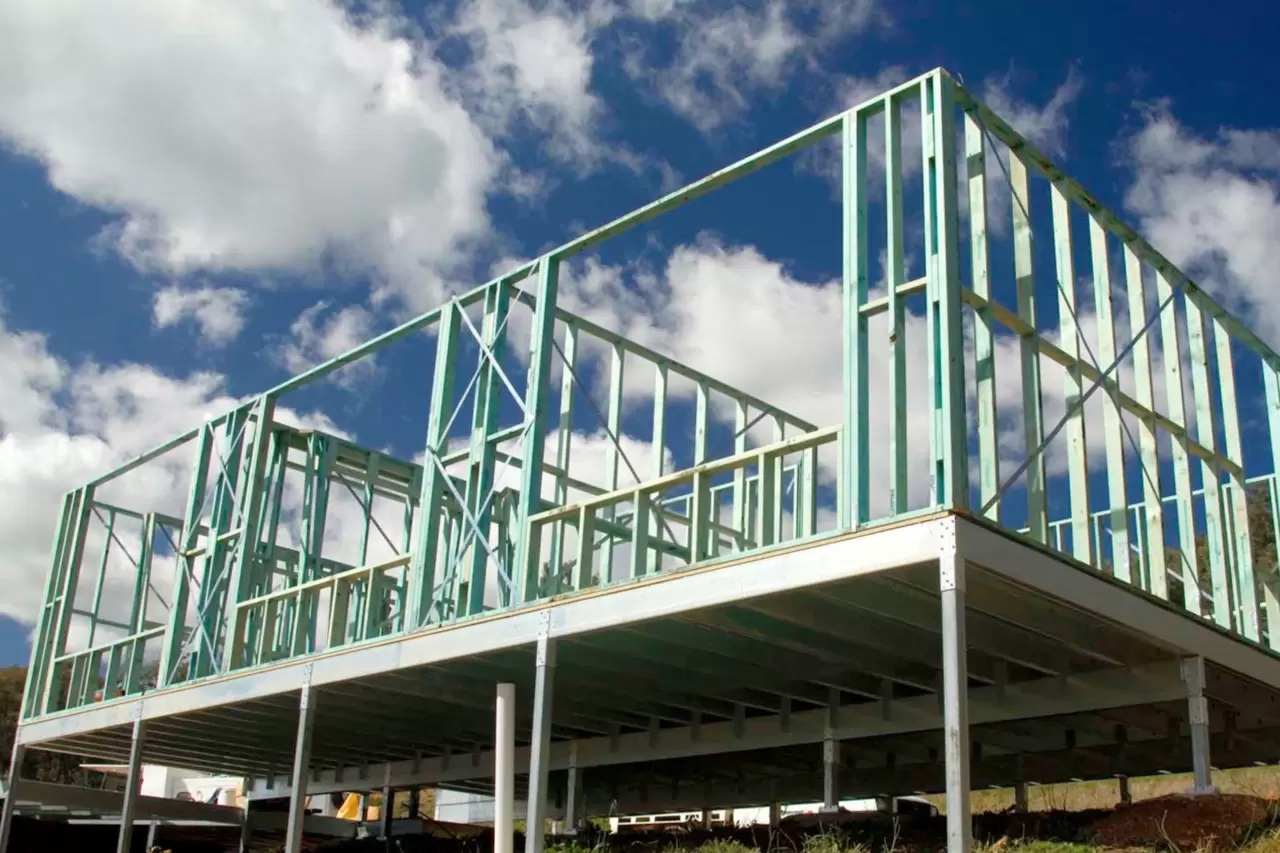 Steel frame house construction on elevated deck platform